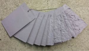 Photo 4 –Prepared concrete compared with three of the ICRI Concrete Surface Profile coupons.
